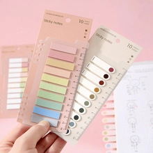 Detail showing 10 colors of sticky notes attached to a transparent ruler with MM scales