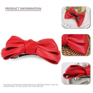 Elegant red PU leather bow hair clip with textured surface and durable metal spring clasp