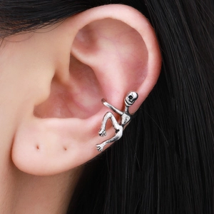 Macro shot of silver climbing human ear cuff on model ear showing unique metallic detail