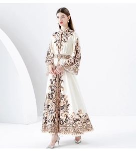 Detail of vintage Baroque floral print on long sleeve dress with flared cuffs and sash