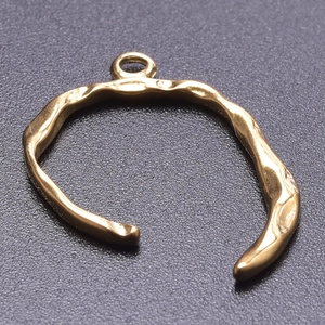 Detailed macro view of an irregular 18k gold-plated stainless steel hammered DIY pendant