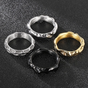 Detail shot of men's titanium steel rings with irregular lava texture in four finishes