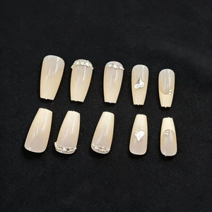 Long coffin-shaped press-on nails in nude gradient with rhinestones and silver heart charms