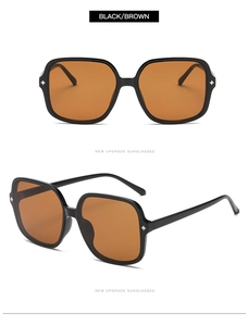Detail of square vintage sunglasses with gold star hinge accents and brown lenses