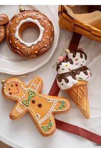 Detailed view of gingerbread man and donut Christmas ornaments with glitter details