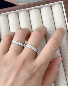 Macro detail of S925 sterling silver feather rings with intricate engraved textures