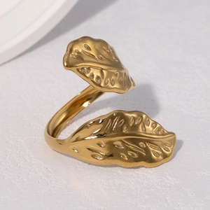Polished gold stainless steel leaf ring shown from a 45-degree angle on a white surface