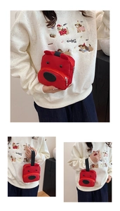 Detail shot of the cute red cartoon puppy handbag with 3D ears and durable nylon fabric