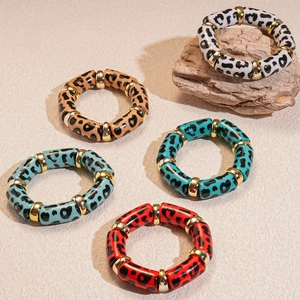 5-piece leopard print acrylic bangle set with gold spacers on natural stone