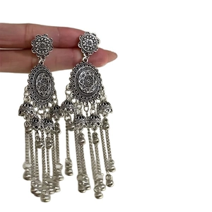 Bohemian silver bell tassel earrings with vintage floral design and ethnic hollow pattern
