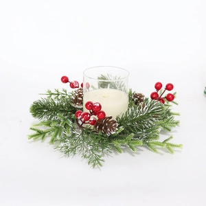 Christmas candle holder with frosted pine needles, red berries, and pinecones on white