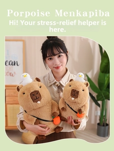 Capybara plush toy set with white bird and orange bag accessory held by a model