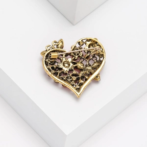 Detailed back view of vintage golden heart brooch featuring hollow metal craftsmanship