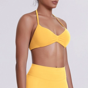 Detail of bright yellow seamless knit yoga bra and leggings with high elastic texture