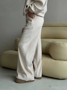 Detailed side view of off-white fleece tracksuit showing loose fit and premium soft texture