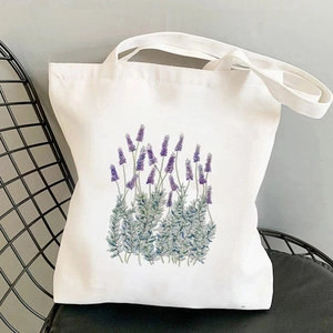 White canvas tote bag with purple lavender floral print on a black grid chair