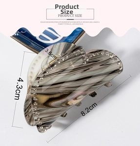 Detailed view of an 8.2cm marble pattern hair claw clip with crystal rhinestones