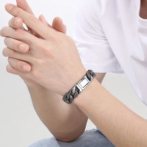 Close-up of 15mm silver Cuban chain bracelet with textured links on a male model's wrist