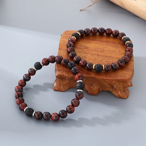 Detailed shot of tiger eye and lava stone beaded bracelets with gold and silver spacers