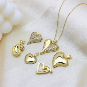 Gold plated heart pendant necklace set with cubic zirconia on elegant satin background