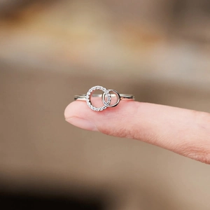 Close-up of interlocking S925 sterling silver rings with pave-set cubic zirconia stones