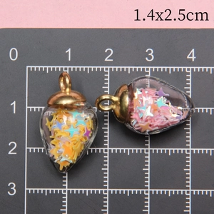 Detailed size view of strawberry glass charms with stars and gold caps measuring 1.4x2.5cm