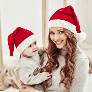 Cozy matching mother and baby Christmas pom-pom knit hats in red and white festive colors