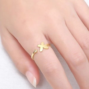 Close-up of adjustable gold ring featuring a frosted star motif and a sparkling diamond