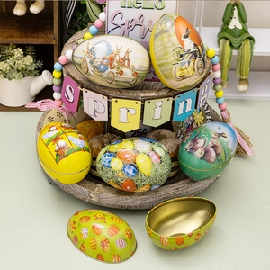 Detailed view of vintage Easter egg tin boxes on wooden tray with rustic decor