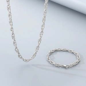 Detailed view of silver twist rope chain necklace and matching bracelet set in stainless steel