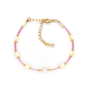 Detail of bohemian pink beads and freshwater pearl bracelet with gold adjustable chain