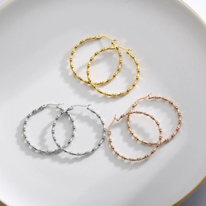 Chic bamboo joint hoop earrings in gold silver and rose gold on a ceramic tray