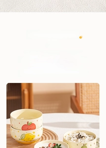 Close-up of ceramic fruit bowls with hand-painted patterns on warm wooden background