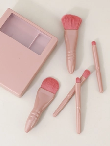 Detail view of 5-piece pink travel makeup brush set with storage case and mirror