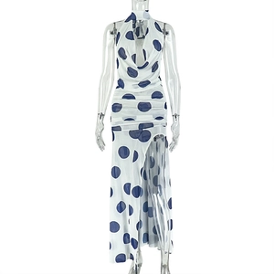 Detail of halter neck and blue polka dot mesh fabric on white backless slit dress