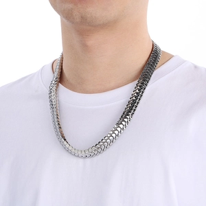 Detail of silver dragon bone chain necklace for men with polished stainless steel finish
