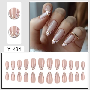 French almond press-on nails with cherry blossom patterns and gold glitter accents
