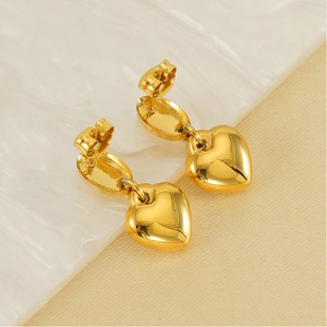 Detailed macro view of 18K gold plated heart earrings with polished finish and butterfly back