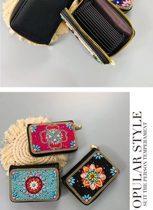 Detail of bohemian card holder with vibrant handmade bead embroidery and accordion slots