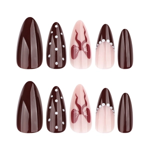 Short almond press-on nails in burgundy and pink with bow patterns and dots