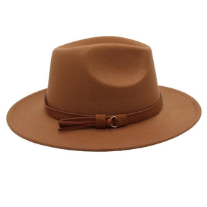 Detail of caramel fedora hat with wool felt texture and belt buckle tassel accent
