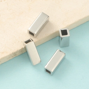 Macro shot of polished hollow rectangular titanium steel beads for DIY jewelry making