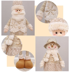 Detailed view of plush Christmas doll featuring snowflake embroidery and sequin fabric textures