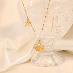 Golden ocean series necklace featuring shell, starfish, and pearls on a silk background