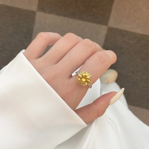Detail of S925 silver ring featuring a round yellow zircon and baguette side stones