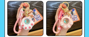Detail of cute silicone cat paw keychains in white and pink with Cat Story hand straps