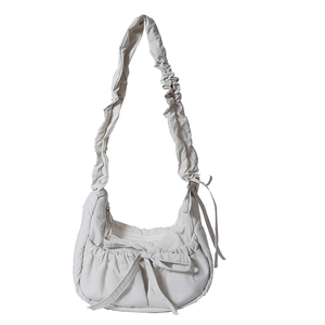 Minimalist cream white ruched nylon shoulder bag with bow detail and pleated strap