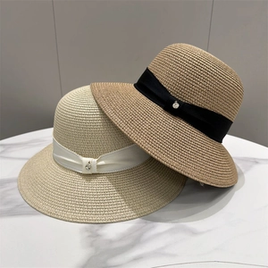 Elegant summer straw sun hat for women with wide ribbon and decorative metal buckle