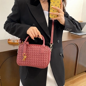 Hand-woven wine red Boston handbag with gold knot detail and removable strap