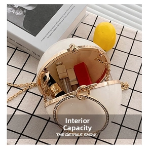Interior view of white pearl sphere bag showing space for lipsticks and small cosmetics